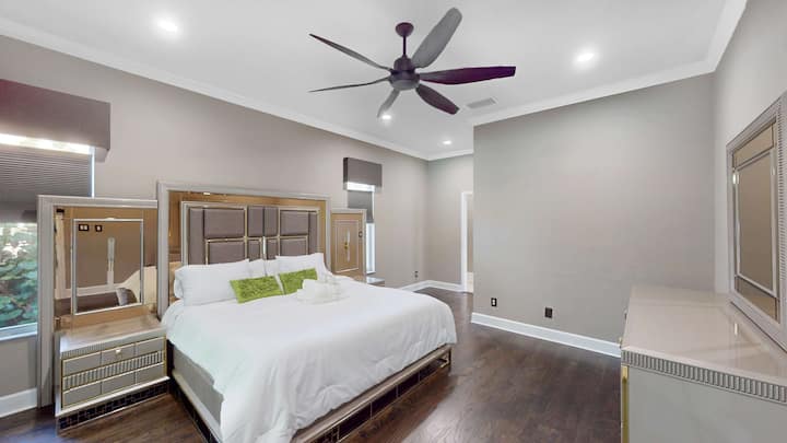 Serene master bedroom w/ soft light & ample space.