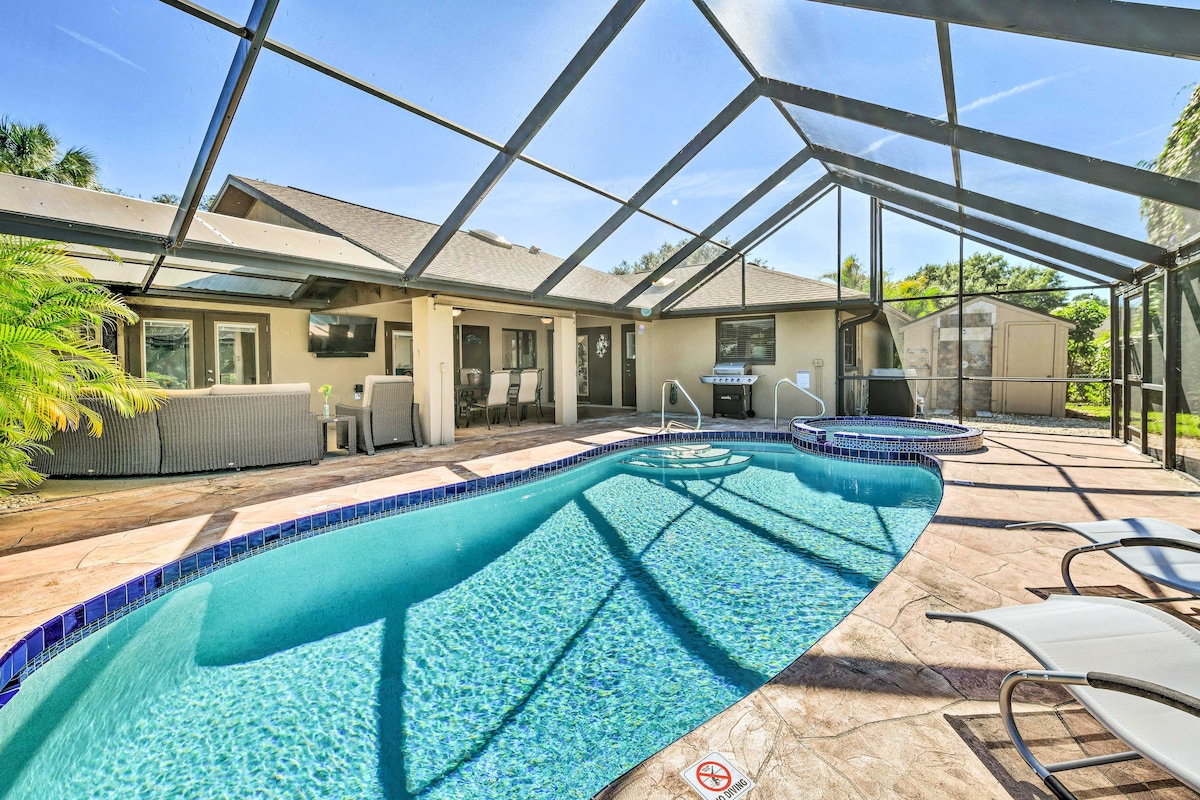 The outdoor lanai features a heated pool with a spa highlighted by a shimmering blue surface. Surrounding the pool are loungers positioned along the deck, while a shaded dining area is visible under the screened enclosure, creating an inviting space for relaxation.
