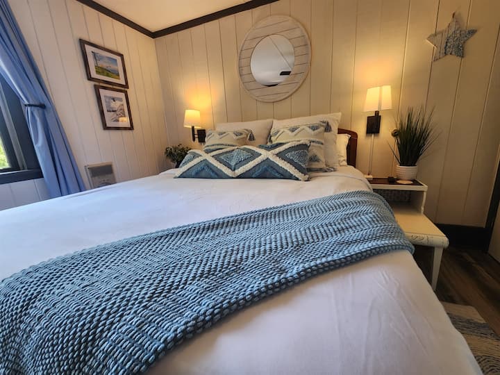 Bedroom includes:queen bed, dresser, two side tables with lamps, closet smart TV