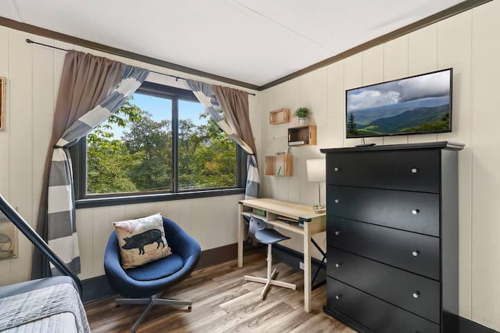 This cozy guest room is perfect for family trips! It features a bunk bed with trundle, allowing for extra sleeping space. A dresser provides ample storage for clothes and belongings, and a work station offers a convenient place to get work done.
