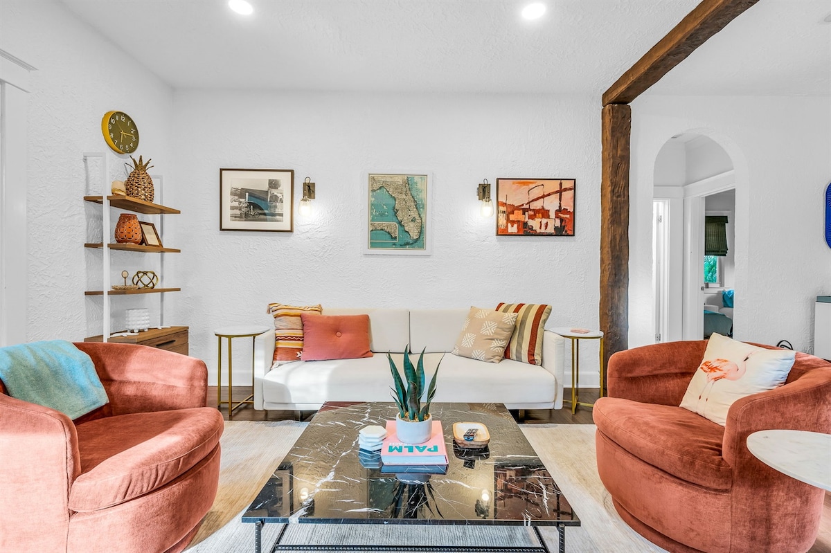 Elegante y acogedor salón con estilo moderno de mediados de siglo, tonos cálidos y un sofá cama tamaño queen para invitados adicionales, perfecto para relajarse con estilo.