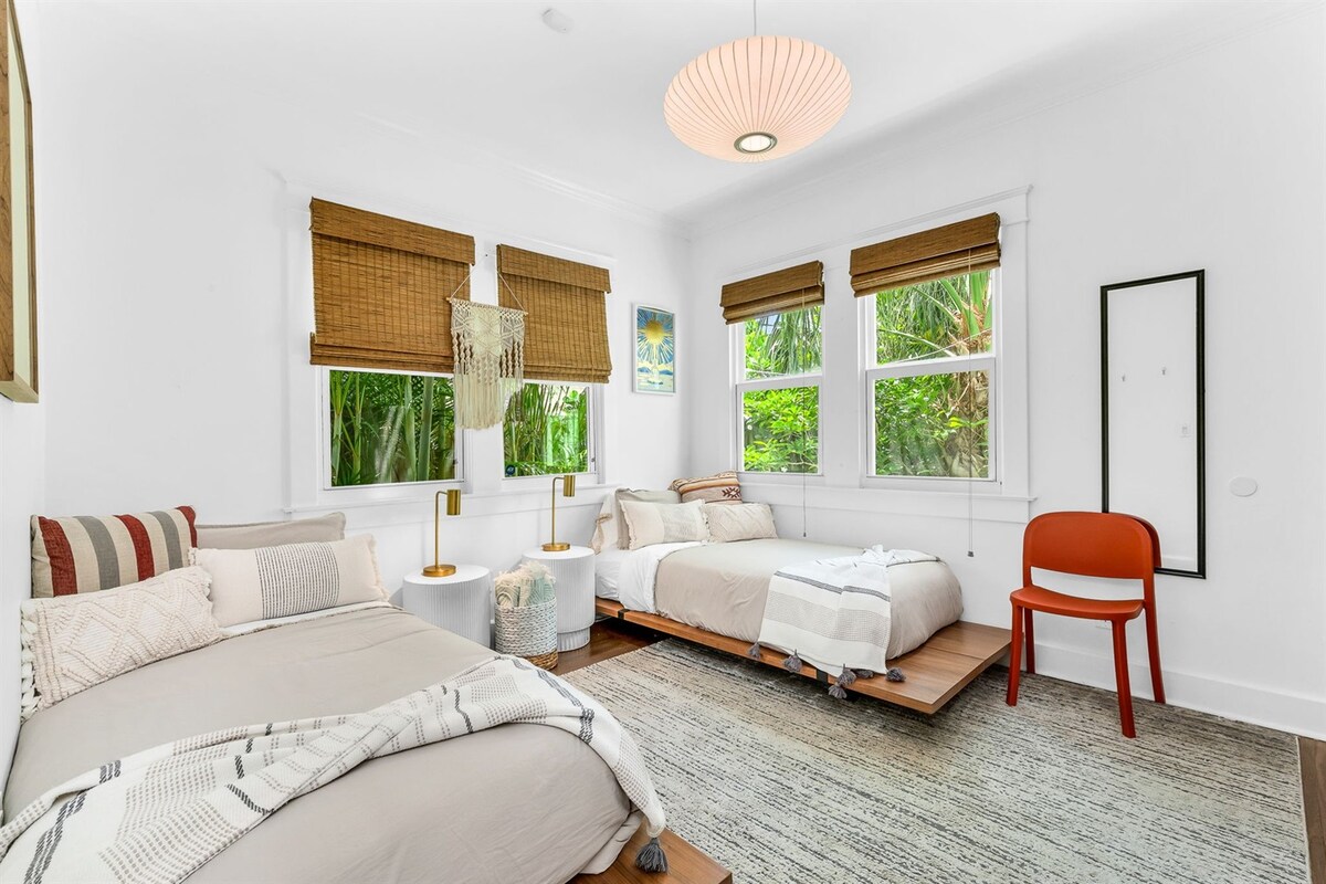 Segundo dormitorio con 2 camas individuales de estilo zen y un televisor inteligente.