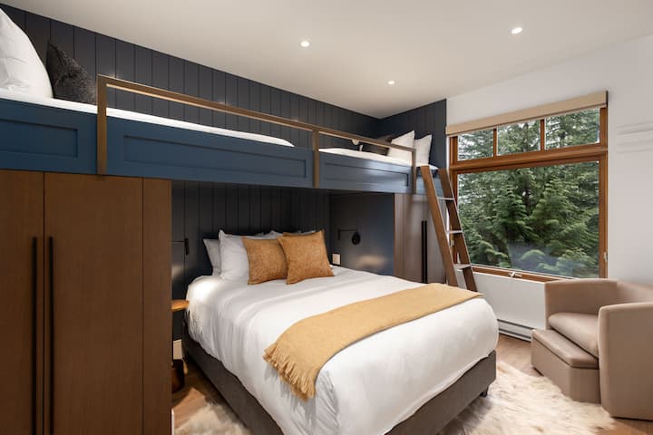 Lliteres a mida amb dos llits individuals sobre un llit «queen size» i armaris