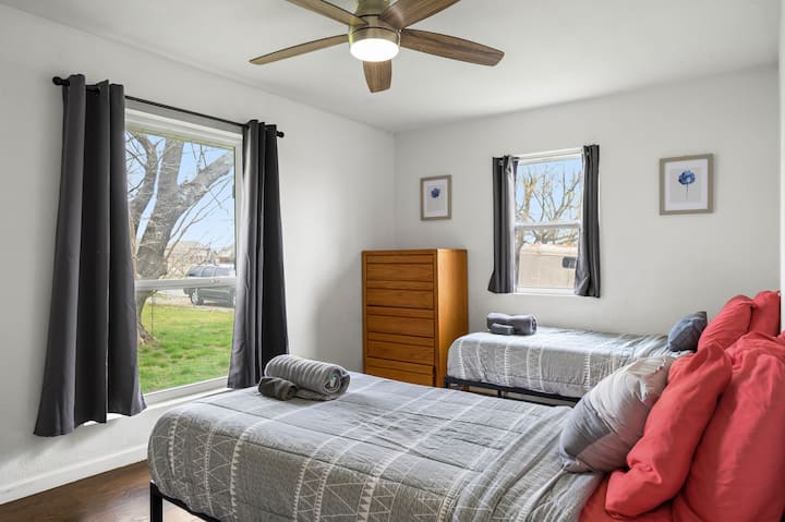 Rest peacefully in your bright bedroom with twin beds, fresh linens, and natural light streaming through the windows. (No TV)