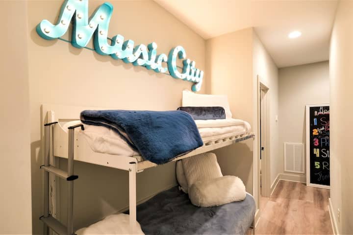 Music City sign above bunkbeds. Goose down pillows, 500 thread count sheets and incredibly soft blankets. Bunkbed location provides a bit of privacy because they’re tucked back in an alcove.