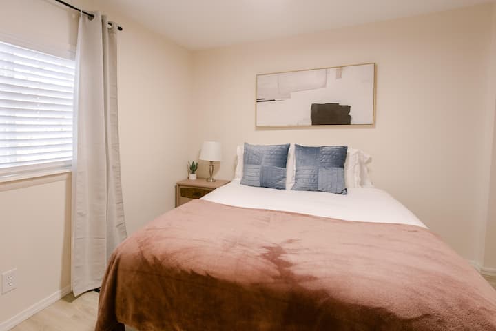 Sleep soundly in Bedroom 2, featuring a luxurious Casper Queen mattress for the perfect combination of comfort and support, ensuring a restful night’s sleep.