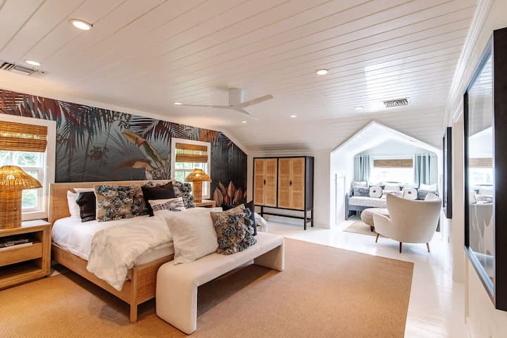 Primary Bedroom Suite at At Ease features a king bed, en-suite bathroom with a soaking tub and shower, bar and coffee station and a walk-in closet. It also has a trundle bed for a smaller child.