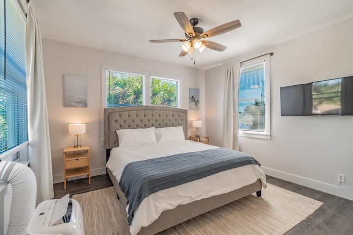 Upstairs Master Bedroom with King bed, wall mounted smart TV & dedicated AC/heating unit