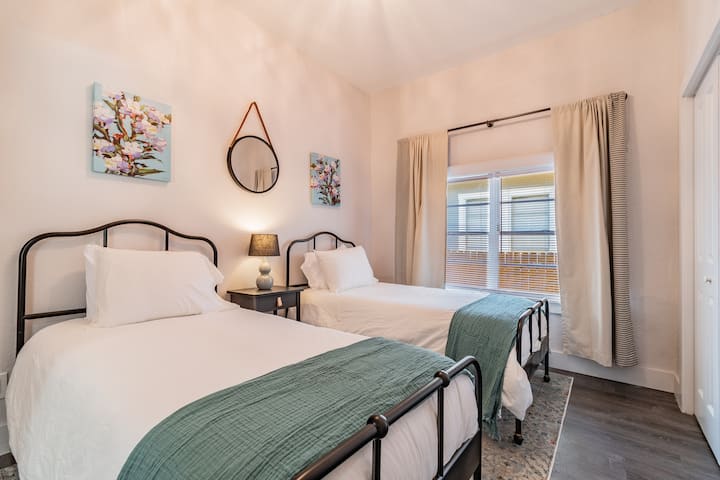 Second bedroom with two twin beds, located next to shared hall bath