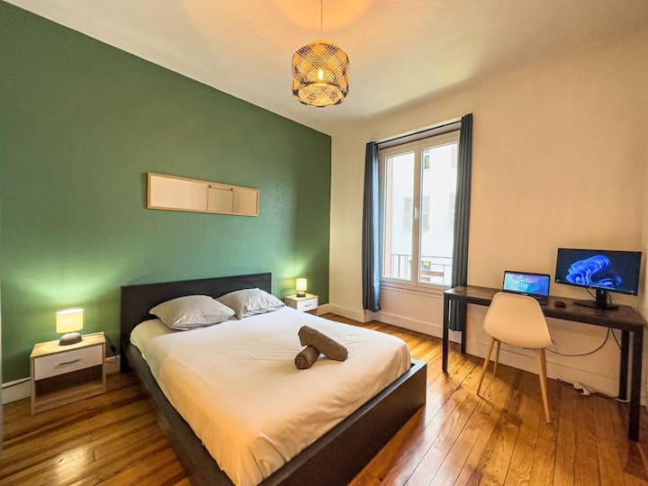 Large bright bedroom with double bed, desk and wardrobe