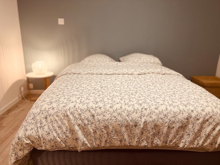 First bedroom with very good hotel quality bedding, a wardrobe to store your clothes and a desk with chair. The bedroom has electric shutters