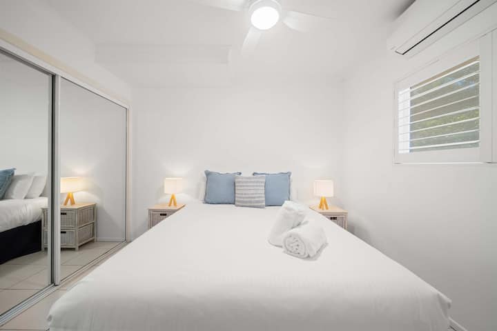 Cozy queen bedroom featuring air conditioning and ceiling fan comfort