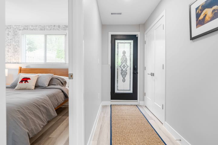 Private entrance hallway to bedroom with bear pillow near UWO