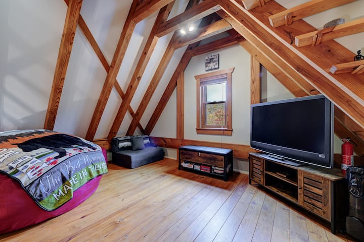 Loft with 6' lounger, twin sleeper chair, cafe table, and games