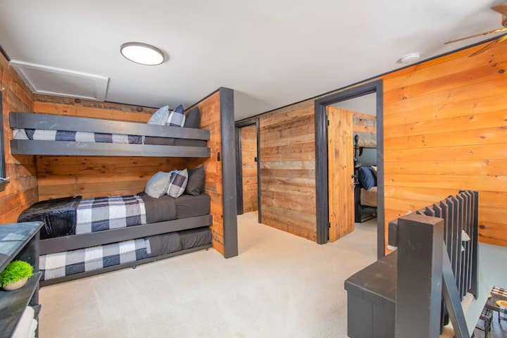 The three remaining sleeping beds are on the large landing as you get to the top of the stairs - they are not in an enclosed bedroom. These beds are comprised of a bunk bed with a pull out trundle underneath it.