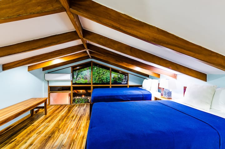 Second-floor Guest Bedroom is perfect for a family vacation in Tamarindo, featuring comfortable bedding, bright décor, and a relaxing atmosphere near Playa Langosta. Ideal for adults or kids, this Costa Rica vacation rental offers style and comfort.