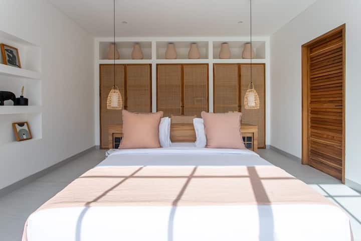Master bedroom with a large rattan closet and a working area