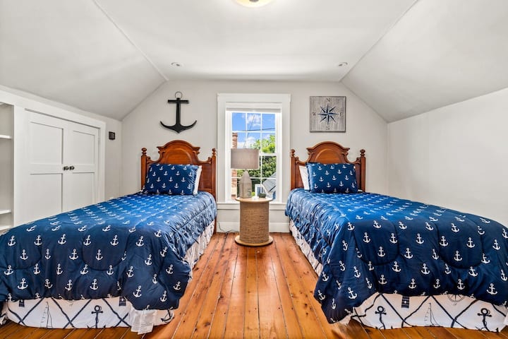Third floor bedroom. Two twin beds & a dresser.