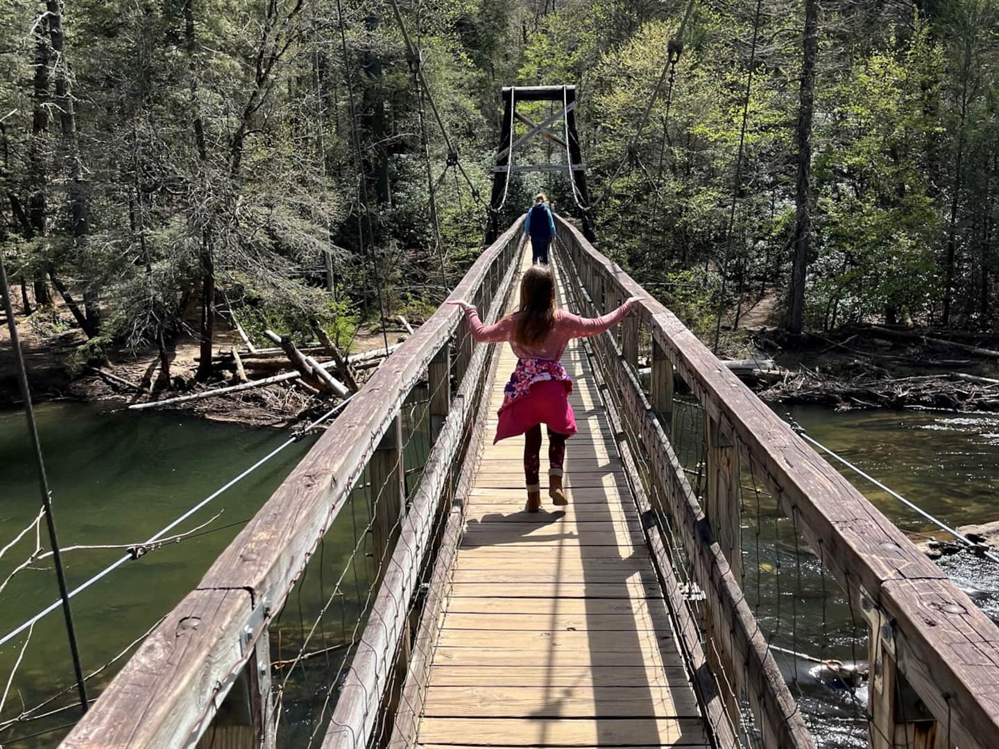 Walk the swinging bridge over the creek with the kids.