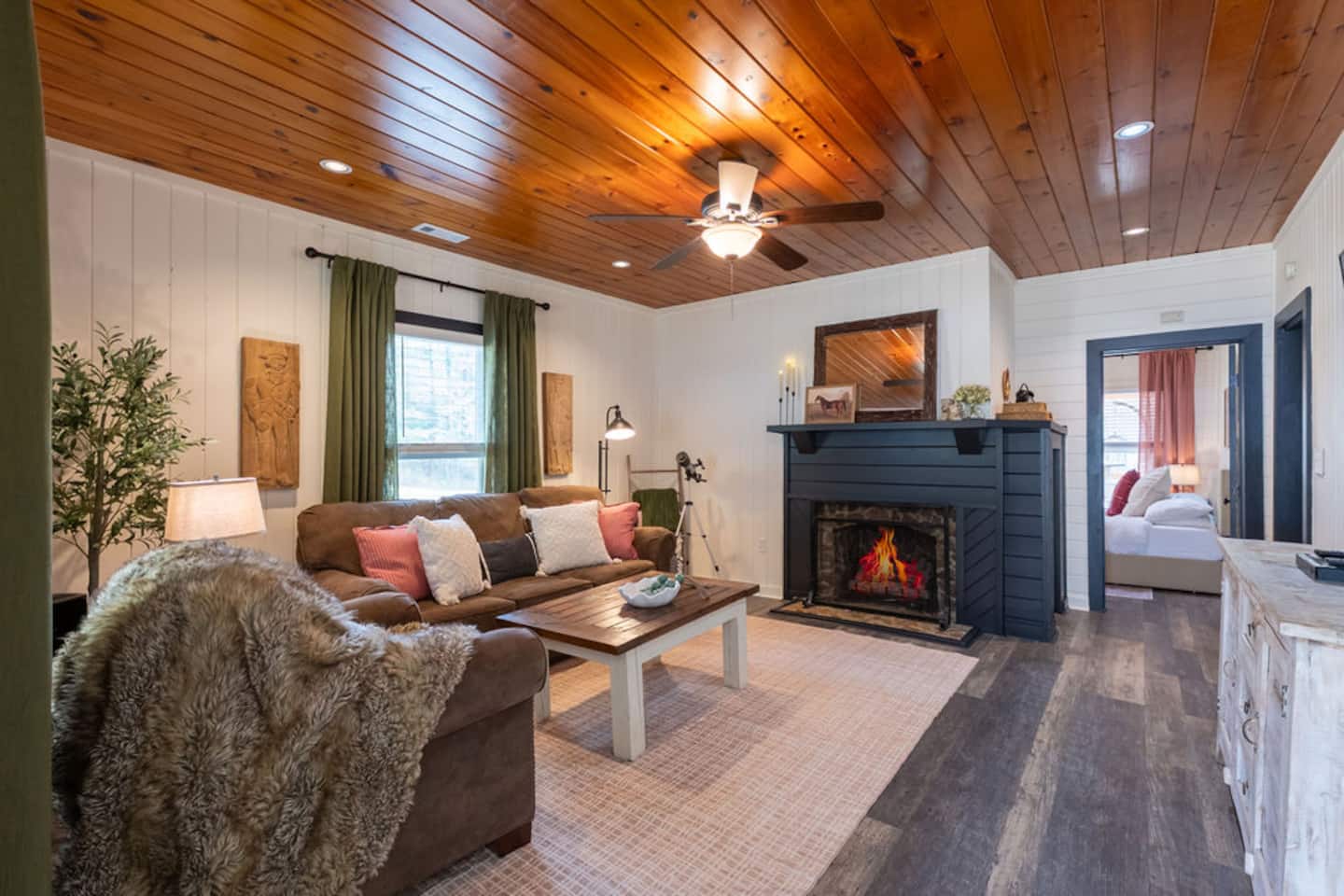 The living room, gas fireplace crackling as the cabin settles into golden-hour quiet
