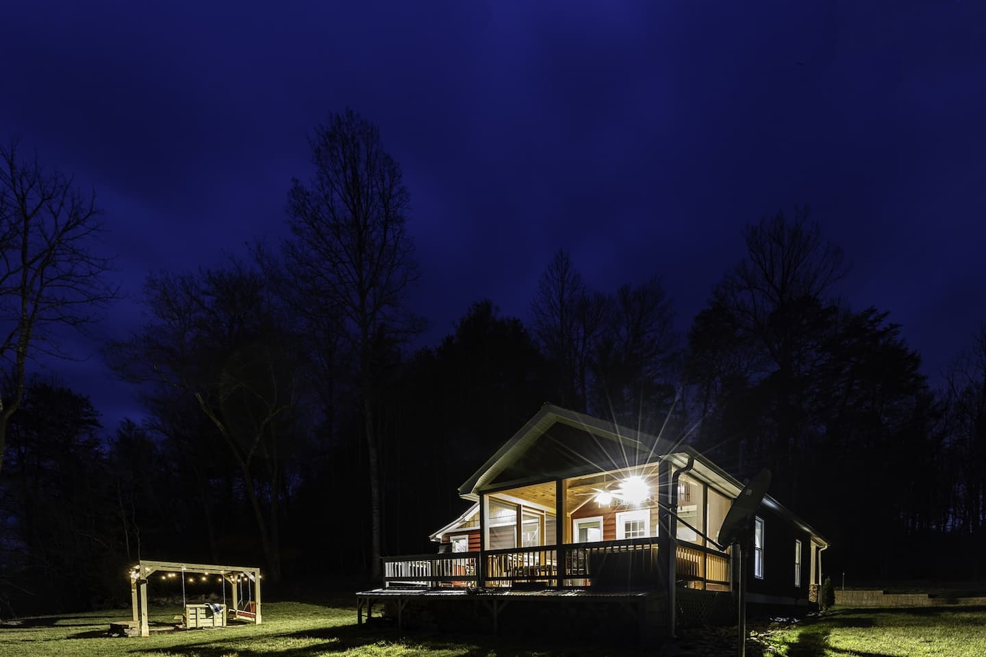Wander out to the porch after sundown and watch the cabin glow against the sky.