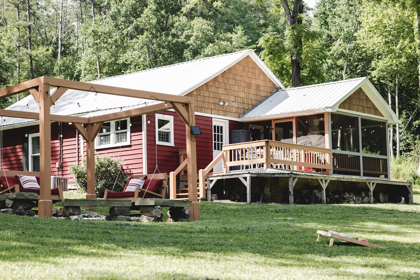 Set up a cornhole game on the lawn, then wander back to the pergola swings and fire pit.
