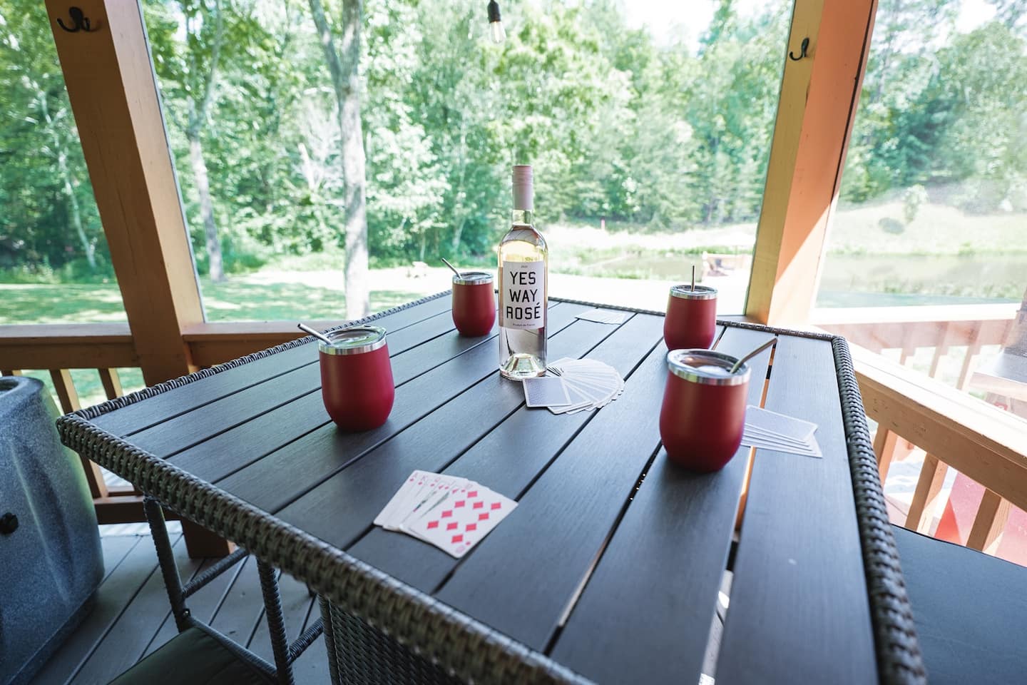 Deal a hand of cards on the screened porch as the pond disappears into the trees.