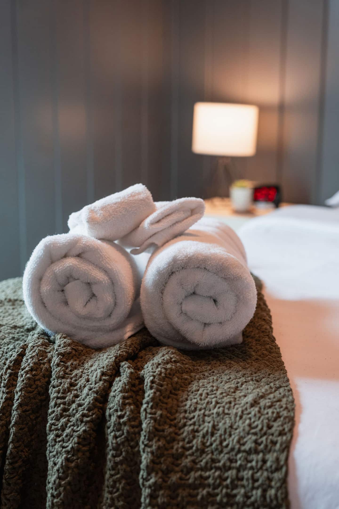 Grab a rolled towel waiting at the foot of the bed.