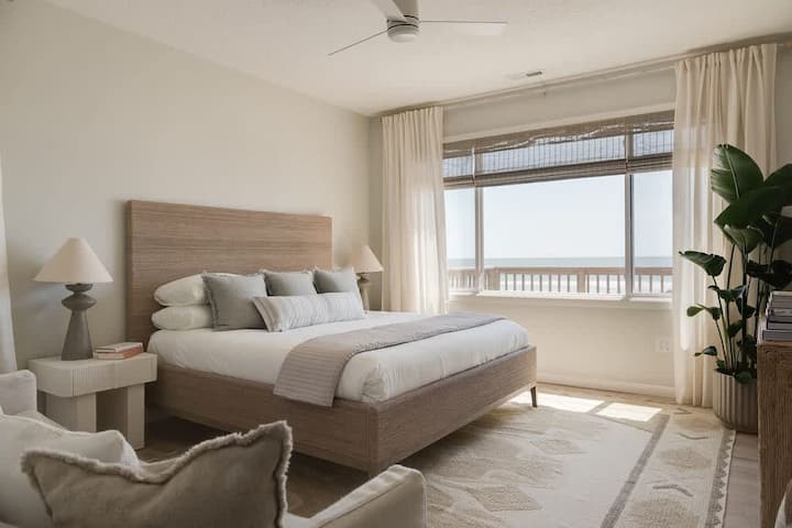 Primary bedroom with a king bed, ocean views, and an en-suite bathroom