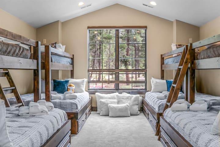 Bunk Room Features 4 twin over queen custom built bunks, TV and lounge area.