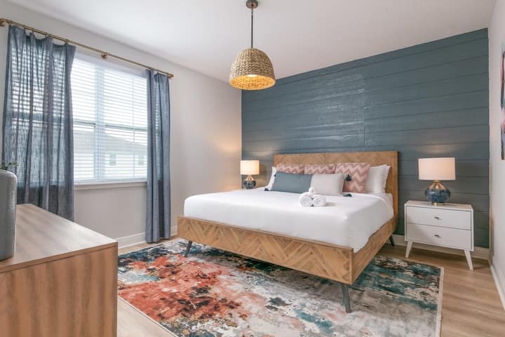 Relax in bright spring comfort in our spacious second-floor king bedroom!  Soft lighting and cheerful seasonal decor make it the perfect retreat after a day of outdoor spring fun.