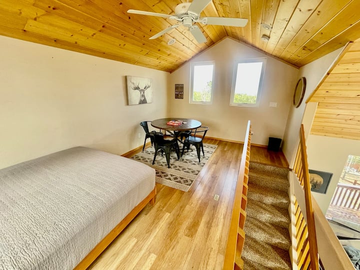 Loft with Queen bed, a portable closet & a table for 4