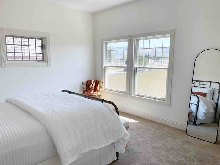 This light-filled room is ready for sleeping in once the blackout shades are closed.