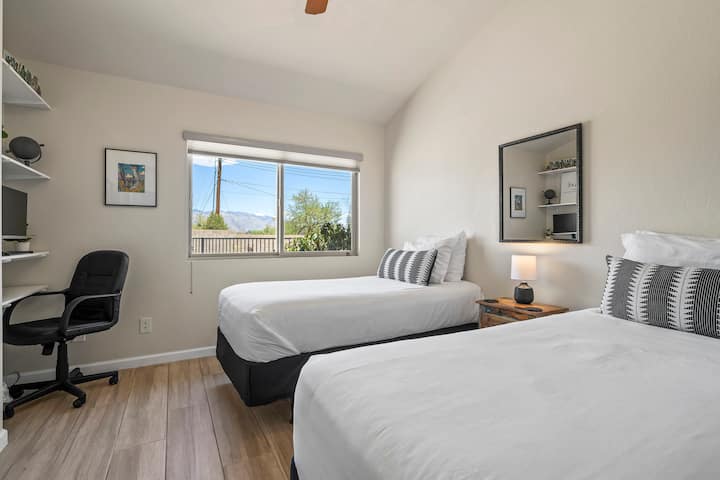 Enjoy a scenic pool view from a room featuring two twin beds and a dedicated workspace. This combination offers both comfort and a delightful backdrop for a relaxing stay.
