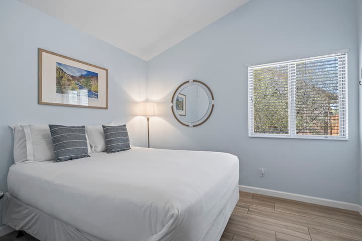 Experience tranquility in a bedroom adorned with calming blue paint, complementing the comfort of a queen-size bed. This soothing combination creates a serene and inviting atmosphere.