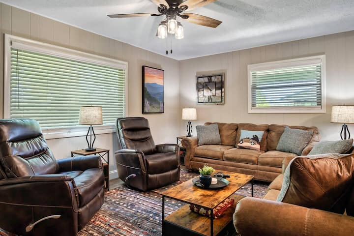 Living room with leather seating, electric fireplace, and 55-inch Samsung OLED smart TV