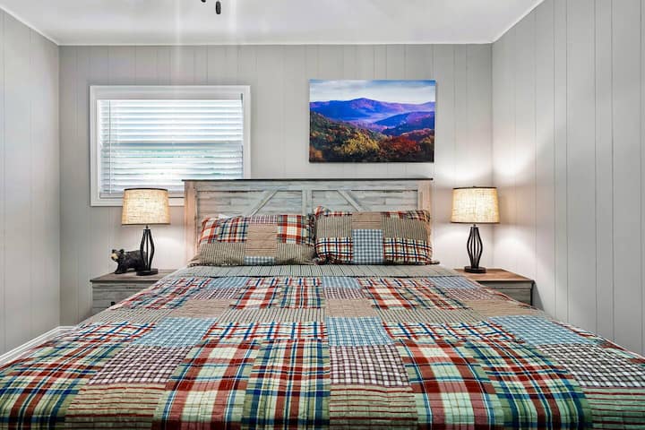 Second bedroom with king bed and mountain landscape artwork