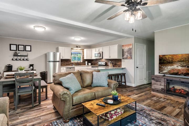 Living room with electric fireplace, open to the kitchen