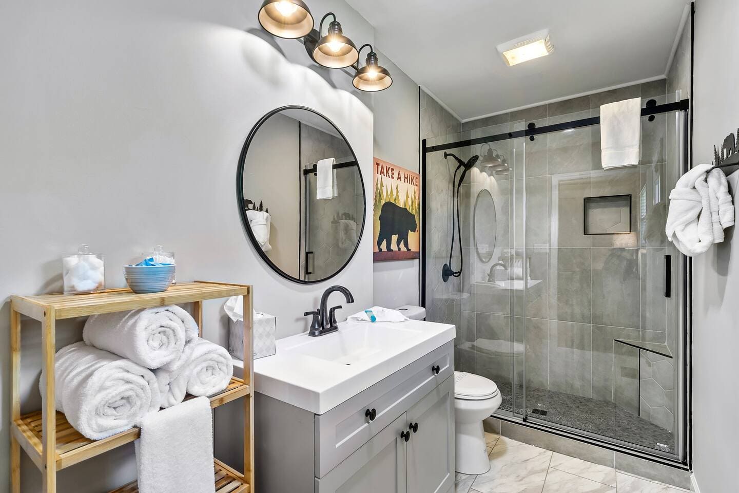 Bathroom with walk-in glass shower and rolled towels