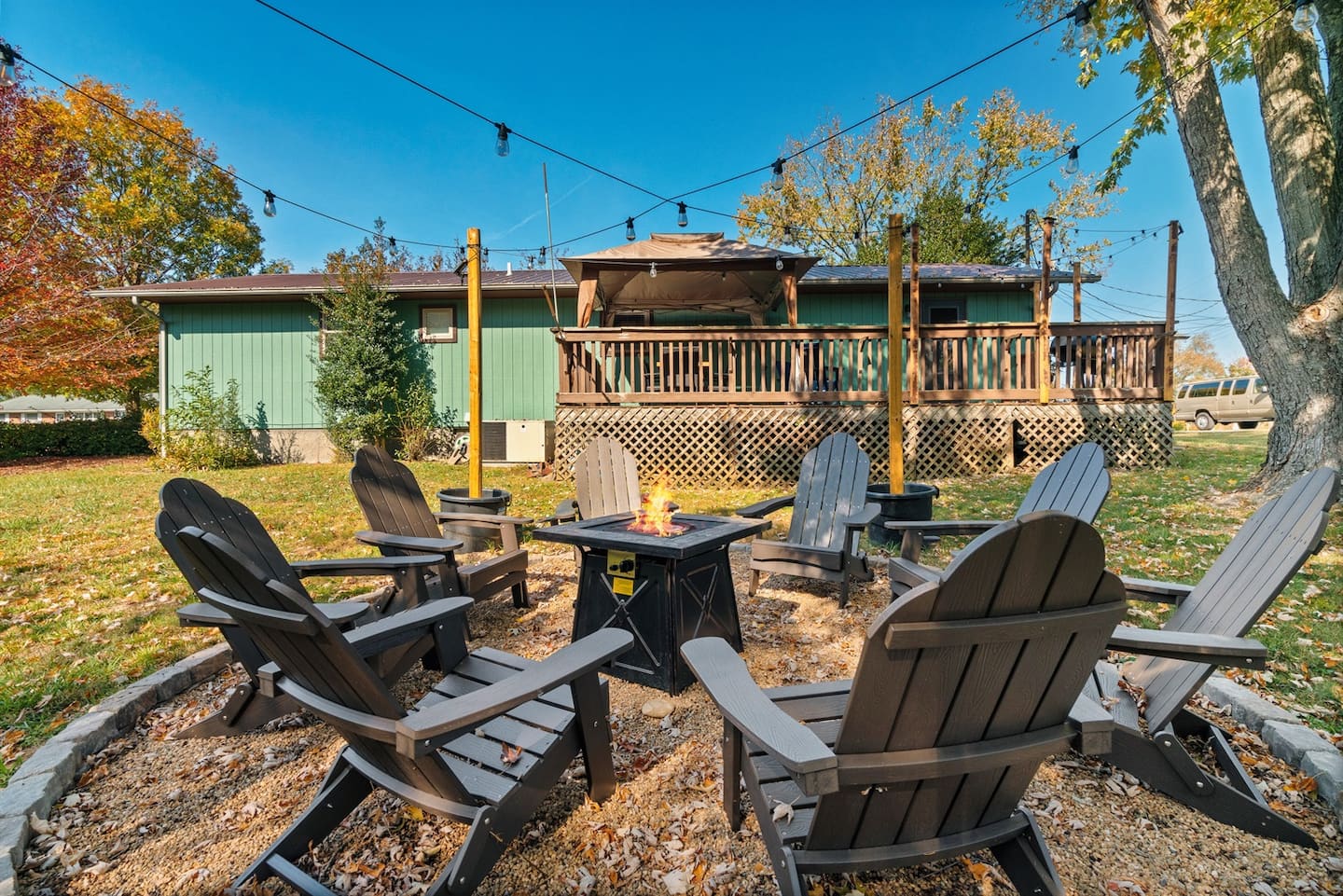 The propane fire pit and Adirondack chairs in daylight