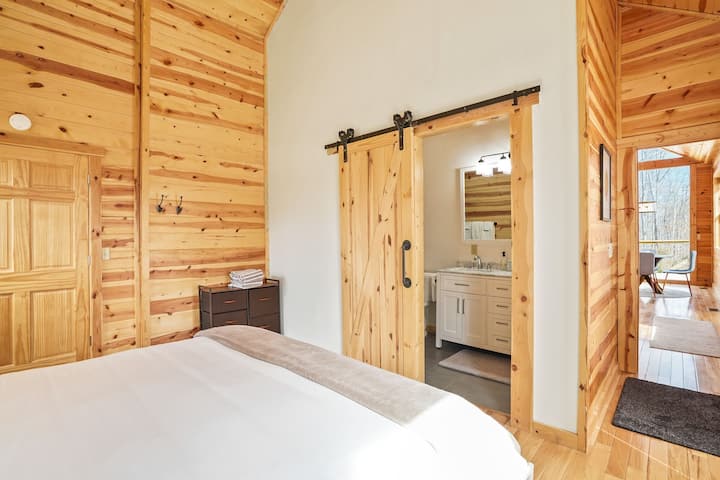 Bedroom: Tranquil retreat with wood accents and convenient en-suite bath for ultimate relaxation!