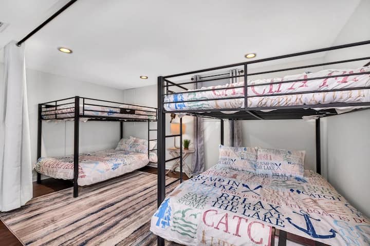 two sets of queen bunkbeds in downstairs living area