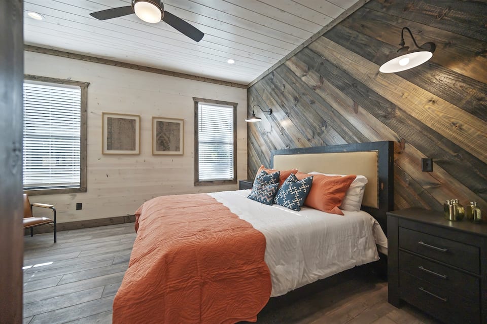 Downstairs bedroom with reclaimed wood accent wall