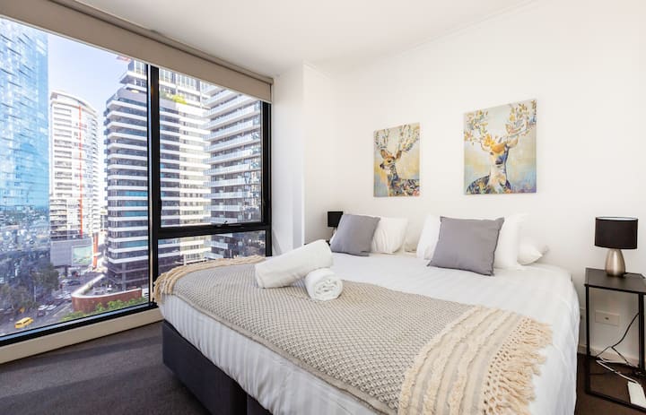 The master bedroom features a plush queen bed and floor-to-ceiling windows where you can overlook the city, or shut the black-out blinds for uninterrupted sleep.