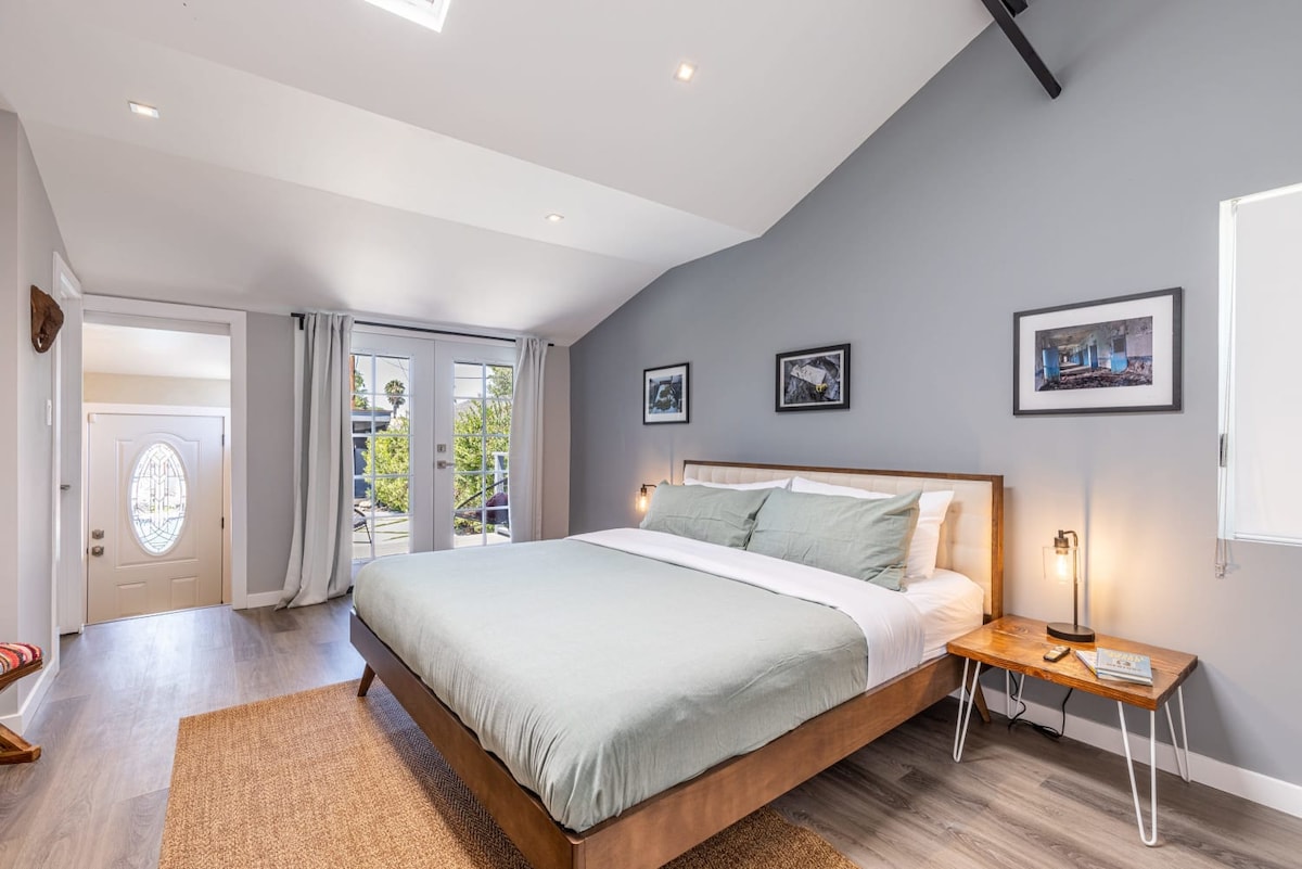 Chumba kikuu cha kulala chenye nafasi kubwa na angavu chenye dari, kitanda cha ukubwa wa kifalme, mapazia 55 ya televisheni na kuzima