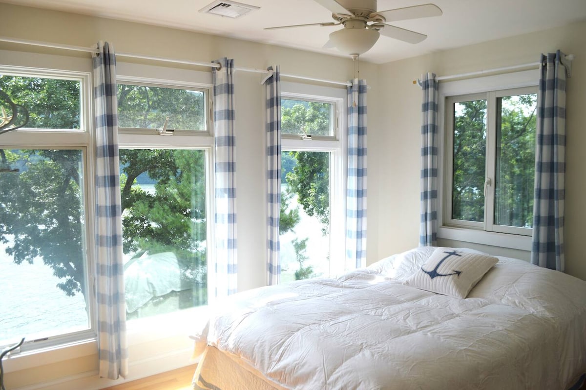 Dormitorio con vista al lago y cama tamaño Queen