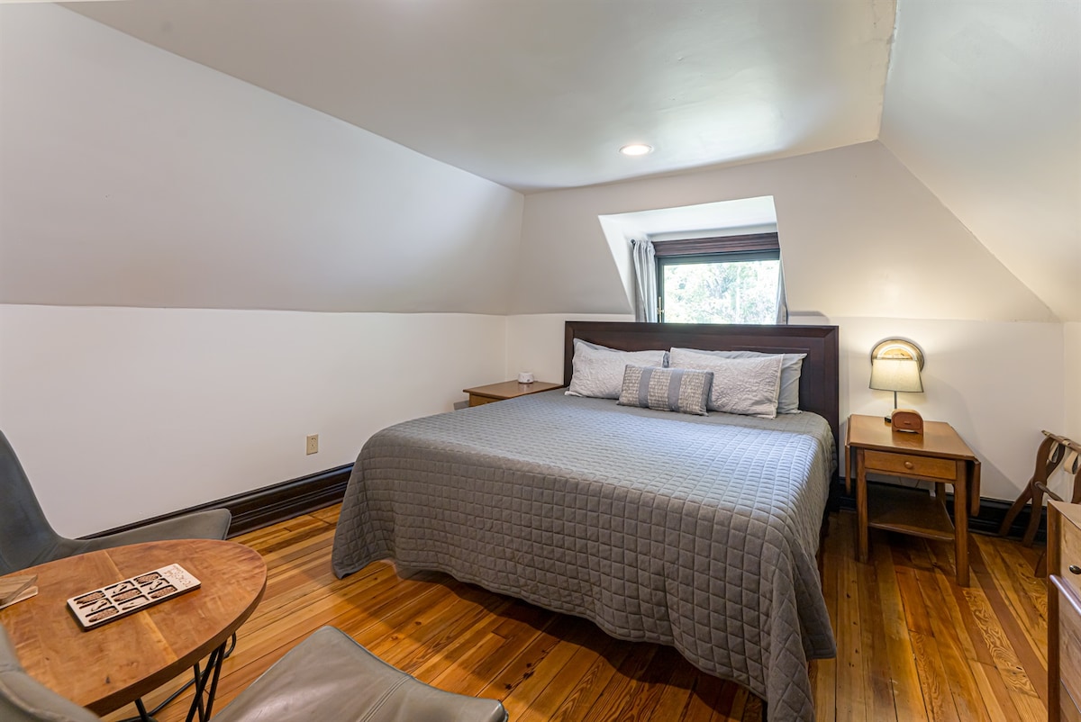 Bedroom #6 (second floor) with a king bed and a full bathroom shared with room #5. The bathroom is accessed through a short hallway, private to rooms 5&6