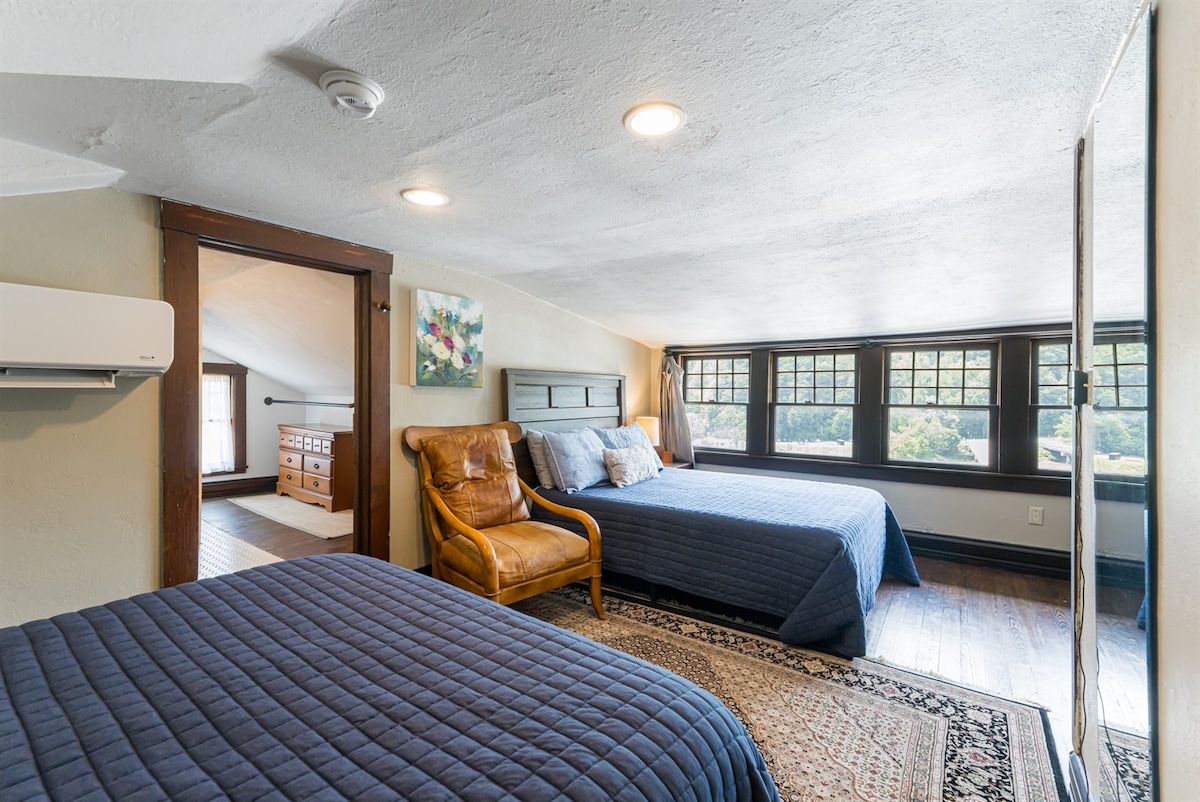 The third floor bedroom with two queen beds and an en suite bathroom. Note the lower ceiling height, I recommend another room for taller guests!