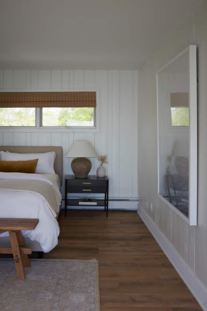 Upstairs primary bedroom with king size bed and gas fireplace.