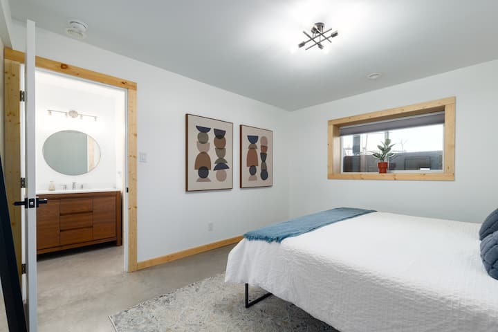 Basement king bedroom with bring east-facing window and 4pc bathroom right outside the door for easy